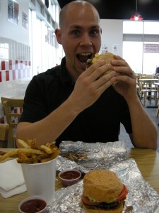 Jamie enjoying hi Five Guys Burger and Fries meal